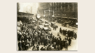 Black-and-white photo of Philadelphians gathering on Market Street in the 1920s.
